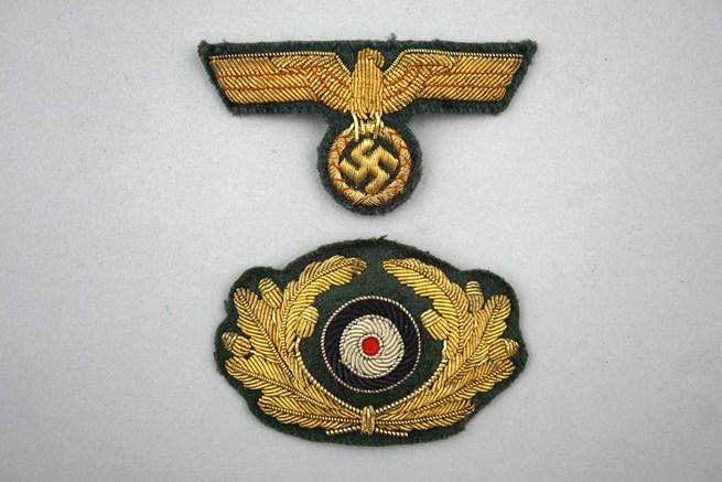 A close-up of a pair of badges

Description automatically generated