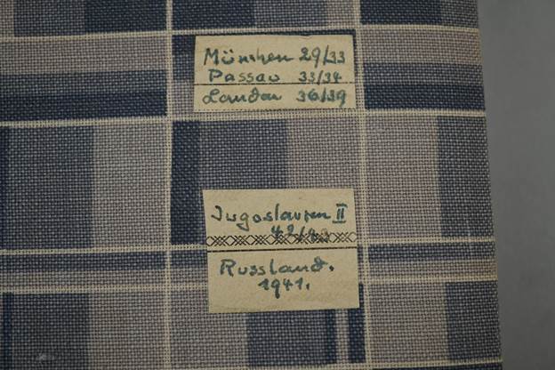 A close-up of a fabric with writing with MetLife Building in the background

Description automatically generated