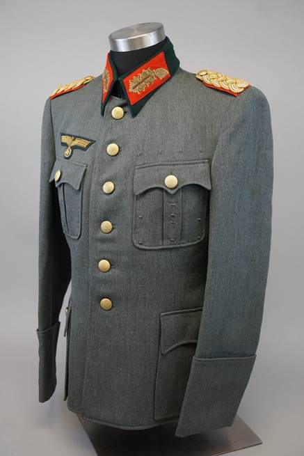 A military uniform with red and gold patches

Description automatically generated