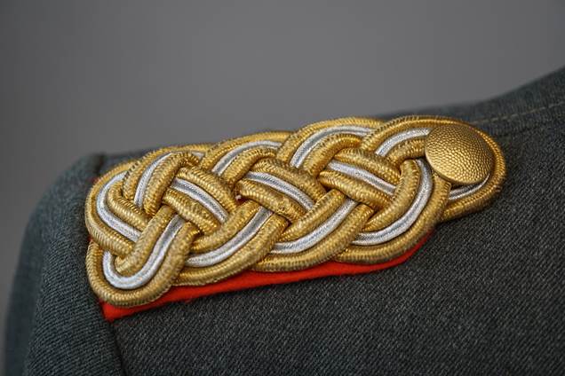 A close up of a gold and silver braided fabric

Description automatically generated