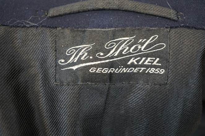 Close-up of a black jacket with white text

Description automatically generated