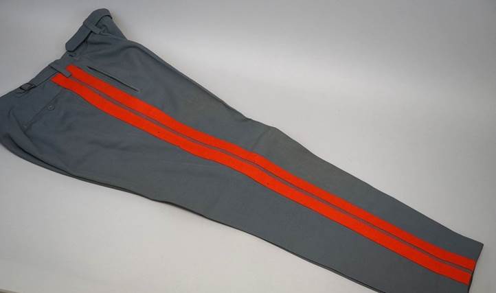A pair of grey pants with red stripes

Description automatically generated