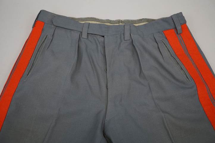 A pair of grey pants with orange stripes

Description automatically generated