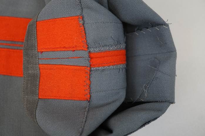 A grey and orange patchwork object

Description automatically generated